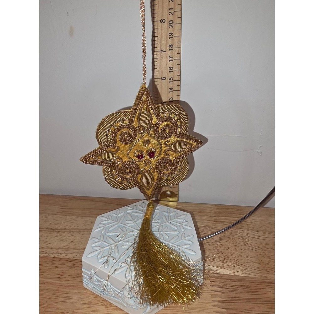 intricately hand-embroidered gold star ornament featuring traditional zardozi